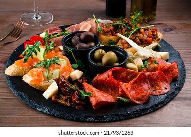 Antipasto Tray With Prosciutto, Salami, Cheese, Olives, Artichokes And Bruschetta. Antipasto Board