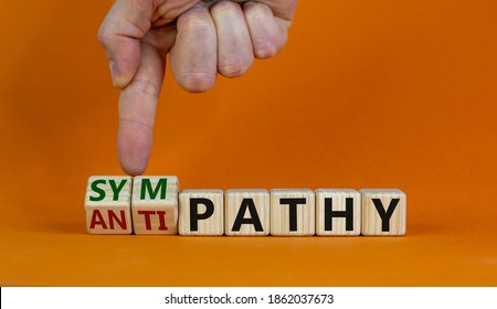 From antipathy to sympathy. Male hand turns cubes and changes the word 'antipathy' to 'sympathy'. Beautiful orange background. Copy space. Psychological concept. - Shutterstock ID 1862037673
