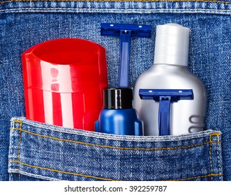 Antiperspirant Deodorant, Shaving Cream, Aftershave Lotion And Disposable Razors In Jeans Pocket. Basic Skin Care Cosmetic Products And Accessories For Men. Toiletry And Cosmetic Travel Kit