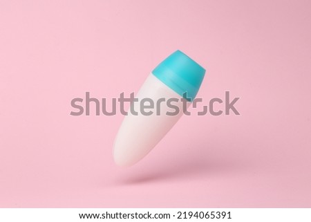 Antiperspirant stick mockup flying in antigravity on pink background with shadow. Levitation object in the air. Beauty concept. Creative minimal layout