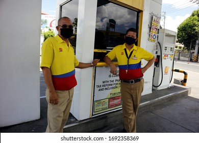 Antipolo City, Philippines - April 2, 2020: Gasoline refilling station workers wait for customers which are scarce during lockdown or community quarantine due to Covid 19 virus outbreak.