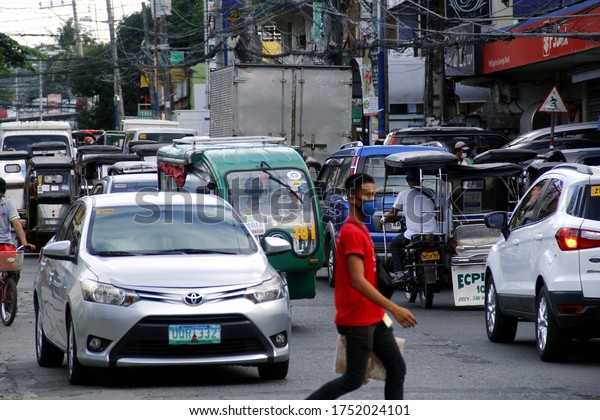 Antipolo City, Philippines - June 1, 2020:\
People and vehicles crowd the street after quarantine rules eased\
up during Covid 19 virus\
outbreak.
