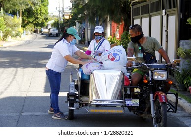 Antipolo City, Philippines - May 11, 2020: Local Government Workers And Members Of The National Police Distribute Relief Goods To Residents During The Lockdown Due To Covid 19 Virus Outbreak.