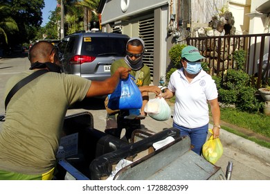 Antipolo City, Philippines - May 11, 2020: Local Government Workers And Members Of The National Police Distribute Relief Goods To Residents During The Lockdown Due To Covid 19 Virus Outbreak.