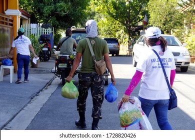 Antipolo City, Philippines - May 11, 2020: Local Government Workers And Members Of The National Police Distribute Relief Goods To Residents During The Lockdown Due To Covid 19 Virus Outbreak.