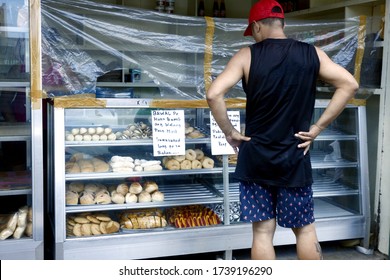 Antipolo City, Philippines - May 21, 2020: Customers Buy From A Bakery Store With Plastic Barrier As Protection During The Covid 19 Virus Outbreak.