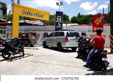 Antipolo City, Philippines - May 5, 2020: Customers In Their Cars And Motorcycles Line Up At The Drive Thru Facility Of A Fast Food Restaurant During The Covid 19 Virus Outbreak.