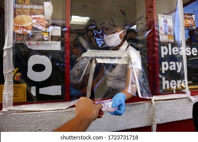 Antipolo City, Philippines - May 5, 2020: Employee Of A Fast Food Restaurant Receive Payment From A Customer At The Drive Thru Window During The Covid 19 Virus Outbreak.