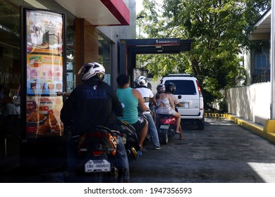 Antipolo City, Philippines - November 13, 2020: Customers In Motorcycles Line Up At A Drive Thru Facility Of A Fast Food Restaurant.