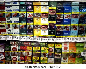 ANTIPOLO CITY, PHILIPPINES - SEPTEMBER 10, 2017: Assorted Packs Of Cigarette With Warning Labels On Display At A Grocery Store.