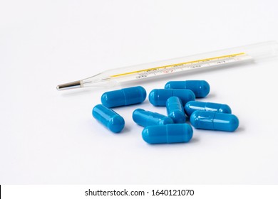 
Antipyretic Tablets And A Thermometer. Treatment.