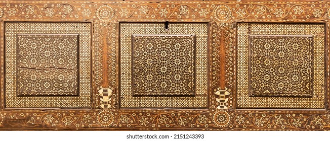 Antique art of wood decoration on a 15th century Italian furniture. Vintage and gothic background image.