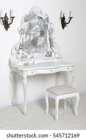 Antique Bedroom Vanity Table With Stool And Mirror In Front Of White Wall