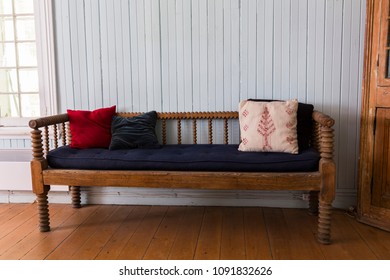 Antique Bench With Tufted And Velvet Cushions In Charming Old Cottage With Wide-plank Floor And Pale Blue Wall