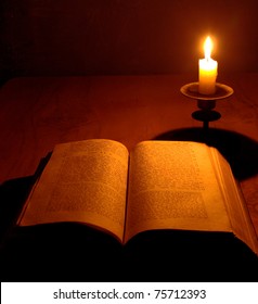 antique  bible on jewish with candle on wooden table