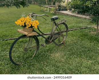 An antique bicycle with a basket of yellow flowers in front of the park - Powered by Shutterstock