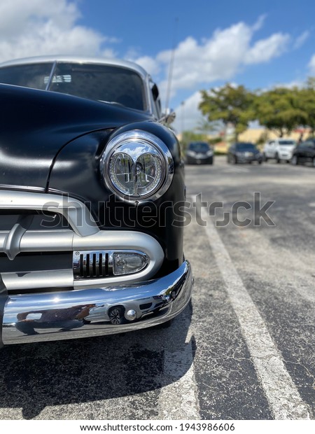 Antique black\
automobile with chrome\
bumper
