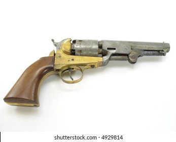 An antique black powder revolver. Its showing its age with bits of wear.