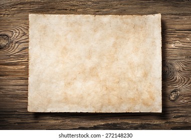 antique blank parchment on very aged dark wood