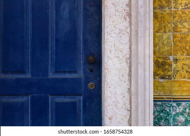 Antique blue door knobs and dandles. Old fashioned door handles and locks. Portuguese azulejo on the wall - Shutterstock ID 1658754328