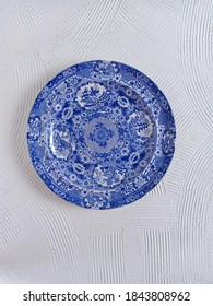 Antique Blue Plate Is Over 45 Years Old With Textured White Background. Taken From Above