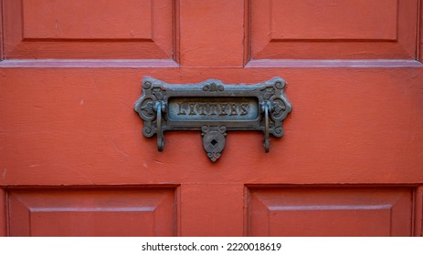 Antique Box On A Red Front Door.