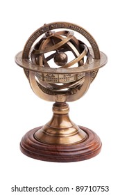 Antique brass armillary sphere on a wooden stand on a white background