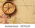 Antique brass compass over old Canadian map background