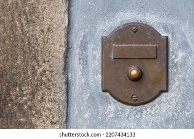 Antique Brass Doorbell With Blank Nameplate On The Rock Wall Of A Building