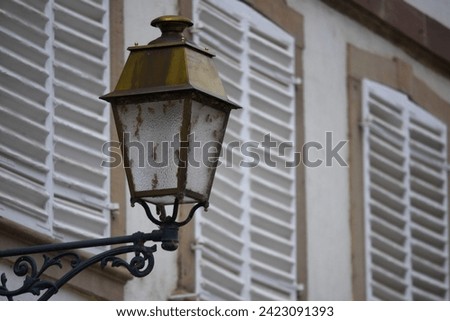 Antique brass street lantern in the picturesque village of Molsheim in Alsace, France. 