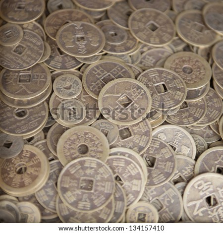 Antique bronze Chinese coins close-up background with selective focus on the middle