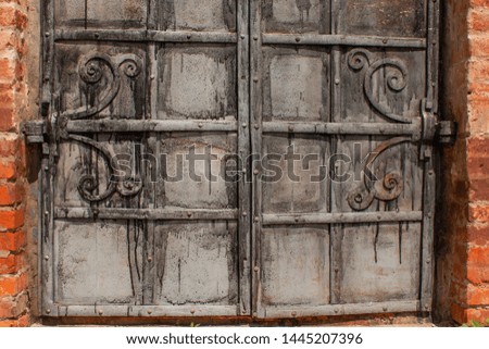 antique carved wooden door in a red brick building