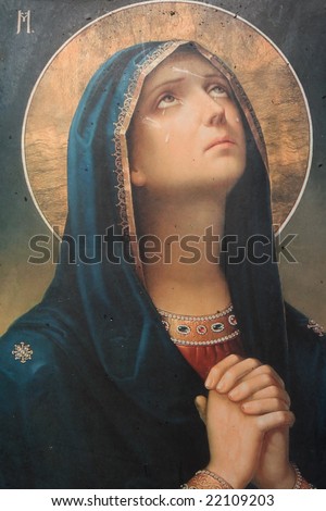 antique catholic icon representing virgin mary praying