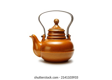 Antique ceramic teapot on the table. Isolated white background.
