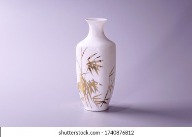 Antique Chinese Eggshell porcelain vase on grey color background. Golden bamboo leaves on White porcelain vase, famous Chinese antique pottery of Ming and Qing dynasties