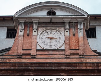 Antique Clock With Roman Numerals Placed On The Old Hospital Building In Parma, Italy.