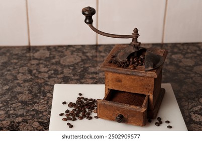 Antique coffee grinder with coffee beans and freshly ground coffee - Powered by Shutterstock