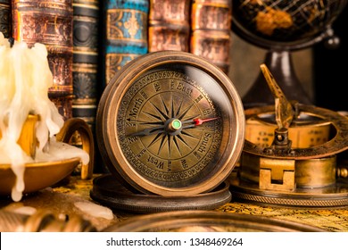 Antique compass on the background of the globe and books. Vintage style. 1565 old map of the year. - Shutterstock ID 1348469264