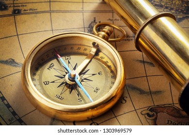 Antique Compass And Spy Glass On Old Map