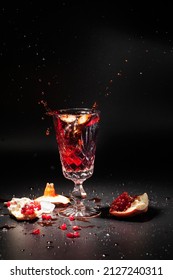 Antique Crystal Glass With Pomegranate Juice On A Dark Background