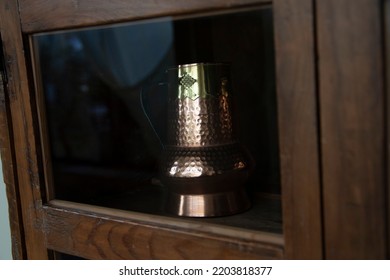 An Antique Cupboard With Copper And Brass Kitchen Utensils. Decoration Concept.