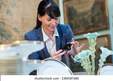 Antique Dealer Photographing Glass Ornament