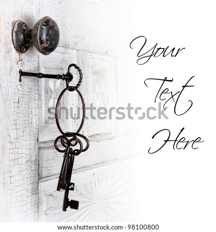 Antique door with keys in the lock isolated area for text