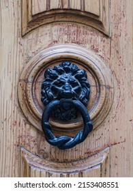 Antique door knocker on antique wooden door. Old Maltese architectural details, Malta. Europe