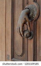 antique doorknob in the shape of a female hand holding an apple
