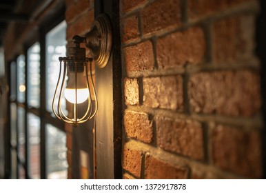 Antique electronic lamp, red wall lamp, high wall lamp, soft light.Red brick wall.Open chain, turn off the lights.hanging at the red brick wall in the building,Wall light brown brick,soft focus. - Powered by Shutterstock