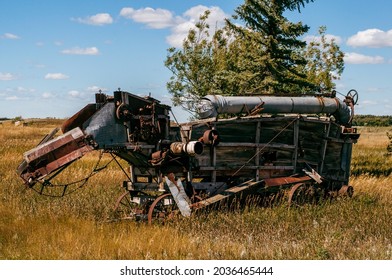 Antique farm equipment sitting in a field in Alberta. Grain thresher, threshing machine
