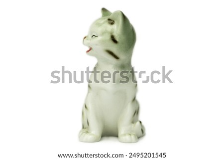 Antique figurine of a cat on a white isolated background. Vintage porcelain 