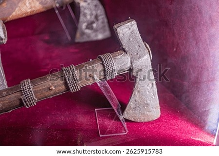 Antique firearm on display in a museum setting, with intricate wooden carvings and polished metal details Close-up shot against blurred background with soft lighting Labeled for identification and