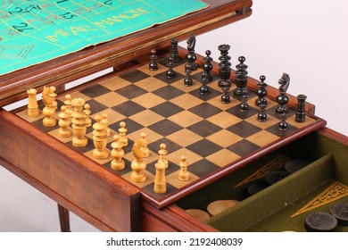 An Antique Fold Out Games Table That Has Multiple Games Inside It, With The Chess Set Currently Out. Isolated On A White Background.